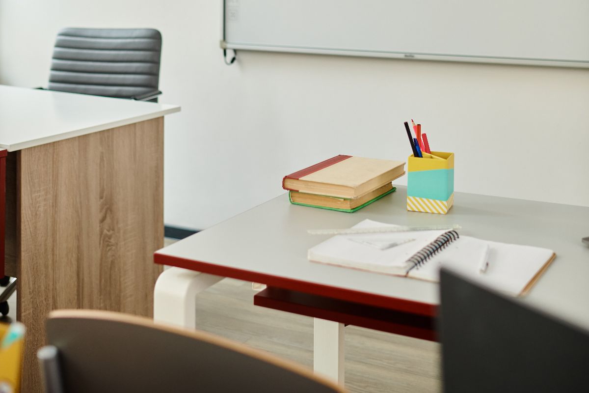 A classroom with a white acoustic board up front 