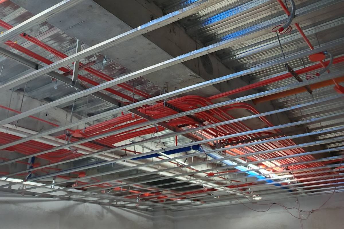 Metal furring being installed indoors